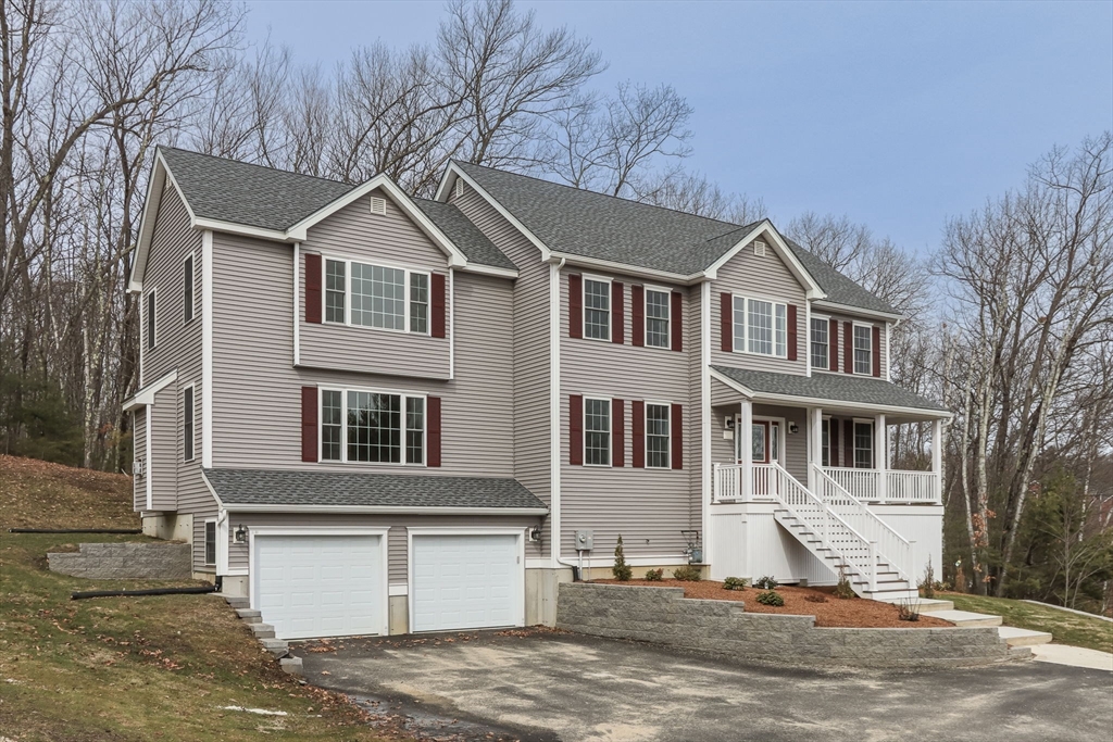76 Robin Hill Road Groton, MA 01450 - Photo 38 of 42 a view of a white house with large windows next to a road