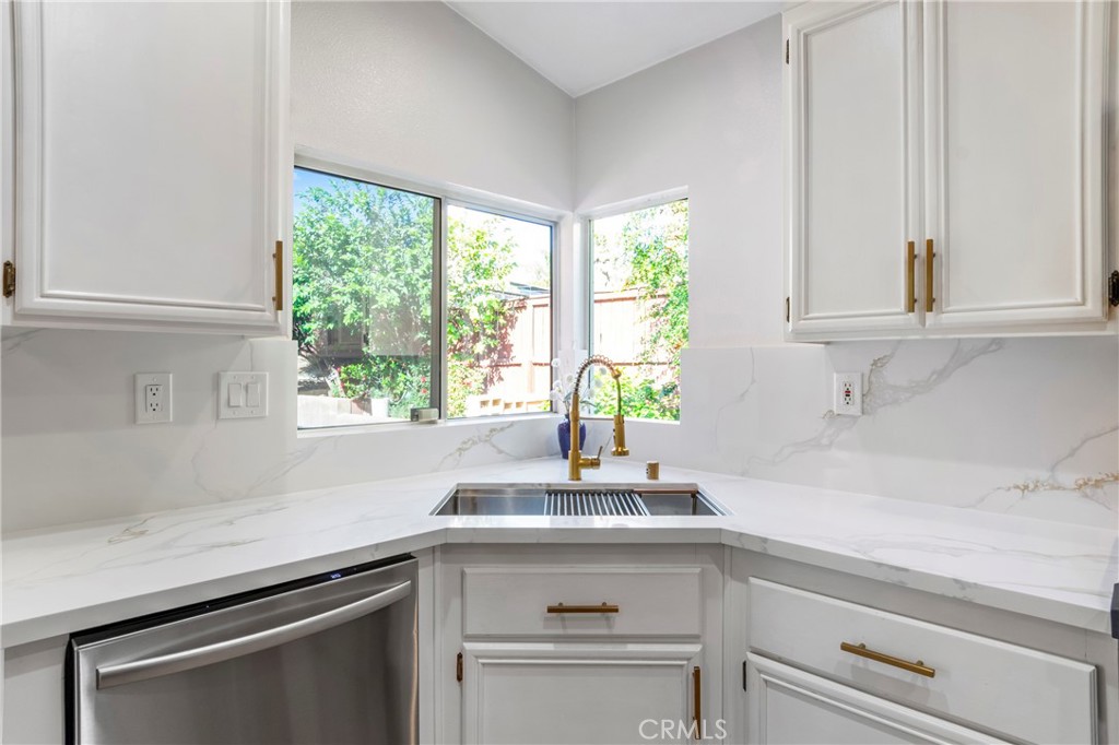 16366 West Sun Canyon Street Riverside, CA 92503 - Photo 9 of 21 a kitchen with stainless steel appliances white cabinets and a window