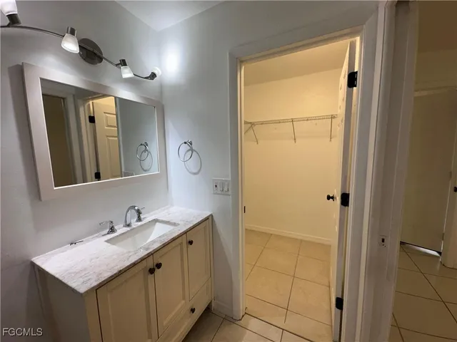 a bathroom with a granite countertop sink mirror and a shower