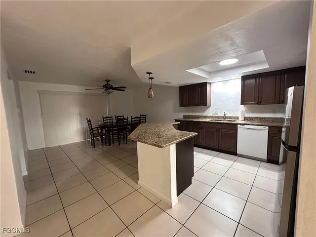 a kitchen with stainless steel appliances a stove a sink a microwave and a refrigerator