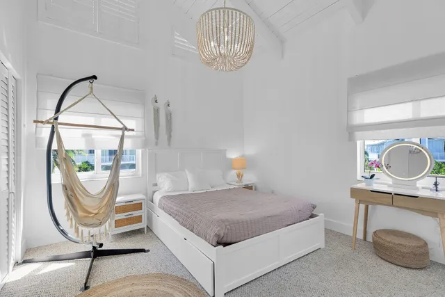 a view of a lake with boats and a car parked in the back