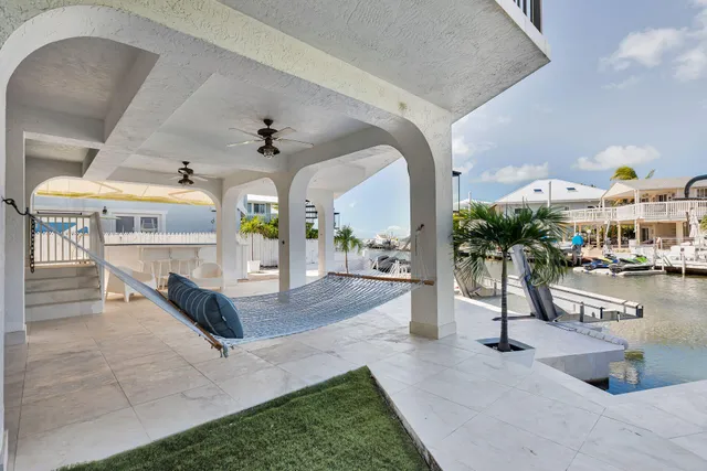 a bedroom with a bed a couch and wooden floor