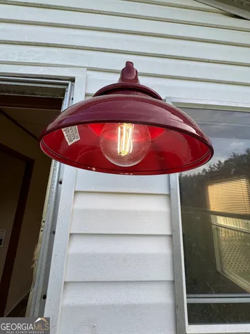 a utility room with wooden floor and washing machine