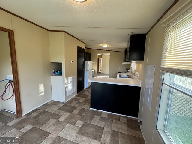 a view of kitchen with stainless steel appliances granite countertop a sink and a stove