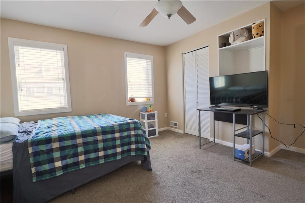 1923 Wharton Street Pittsburgh, PA 15203 - Photo 22 of 34 a bedroom with a bed and a flat screen tv