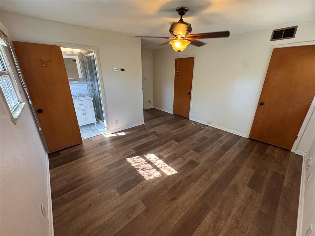 1148 Simpson Drive Hurst, TX 76053 - Photo 12 of 17 a view of a livingroom with wooden floor and staircase