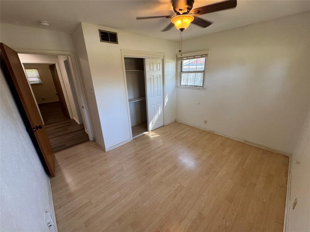 1148 Simpson Drive Hurst, TX 76053 - Photo 14 of 17 an empty room with windows and fan