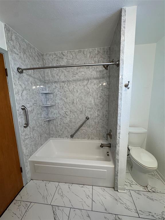 1148 Simpson Drive Hurst, TX 76053 - Photo 16 of 17 a bathroom with a tub and toilet