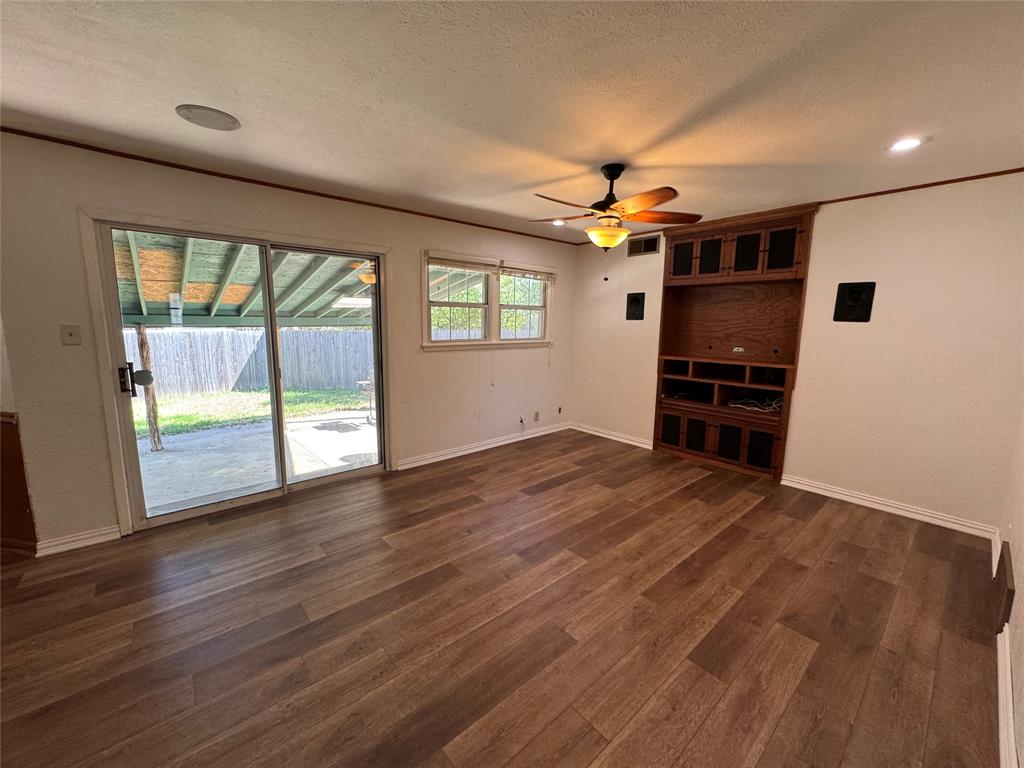 1148 Simpson Drive Hurst, TX 76053 - Photo 4 of 17 wooden floor in an empty room with a window