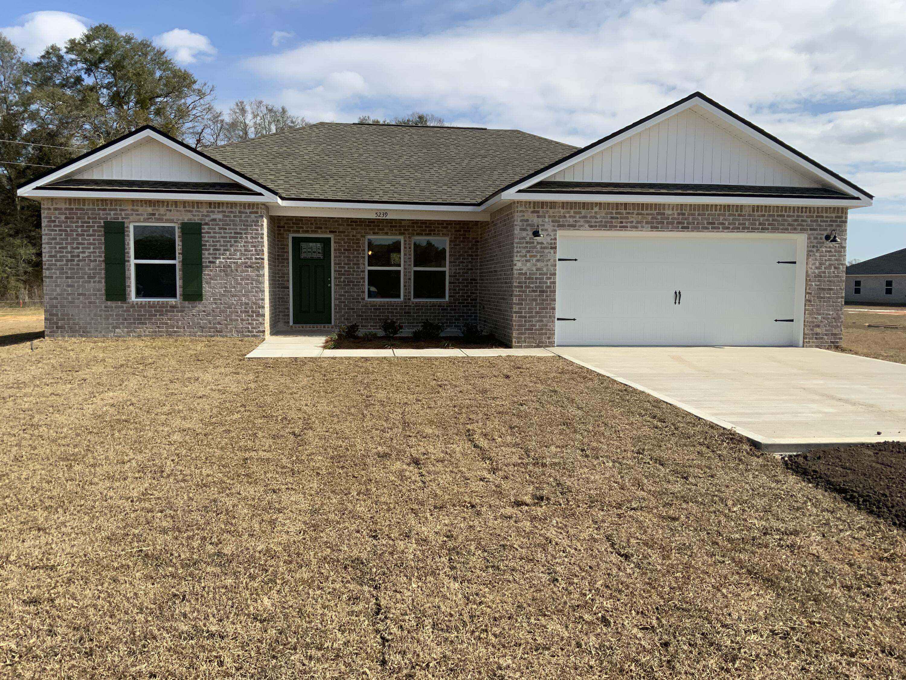 5239 Griffith Mill Road Baker, FL 32531 - Photo 1 of 9 a front view of a house with a yard and garage