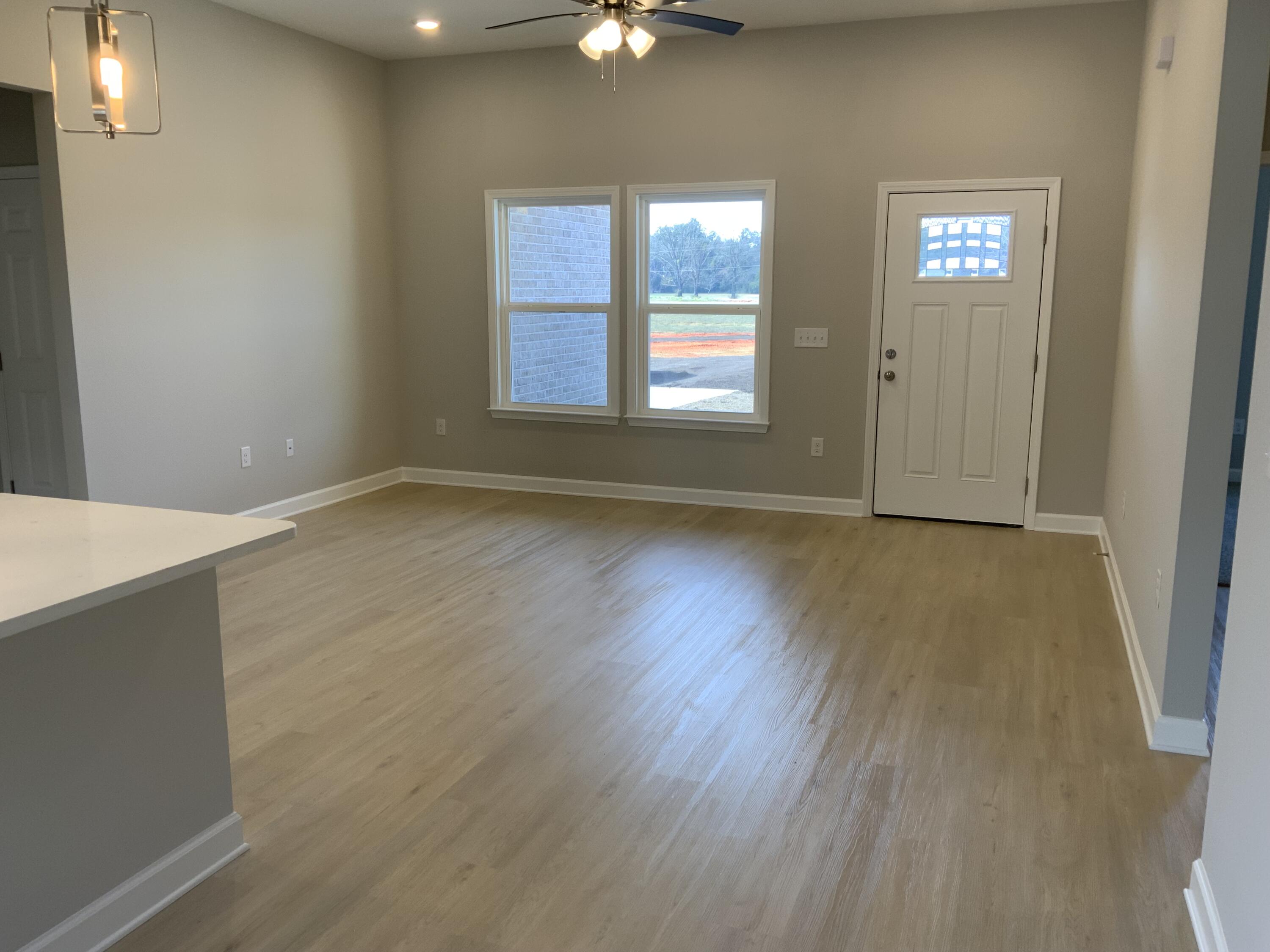5239 Griffith Mill Road Baker, FL 32531 - Photo 2 of 9 an empty room with wooden floor and windows