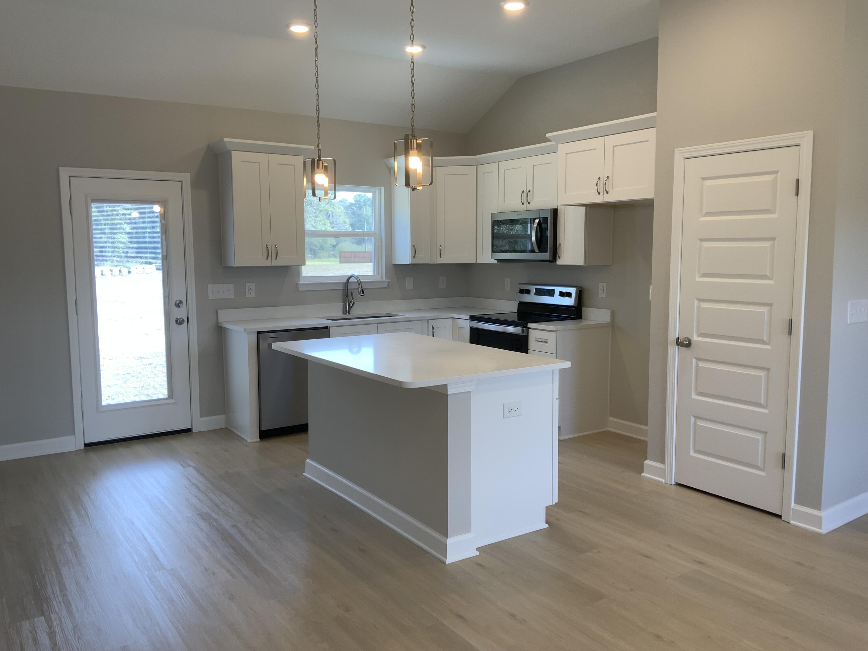 5239 Griffith Mill Road Baker, FL 32531 - Photo 3 of 9 a kitchen with stainless steel appliances granite countertop a sink stove and refrigerator