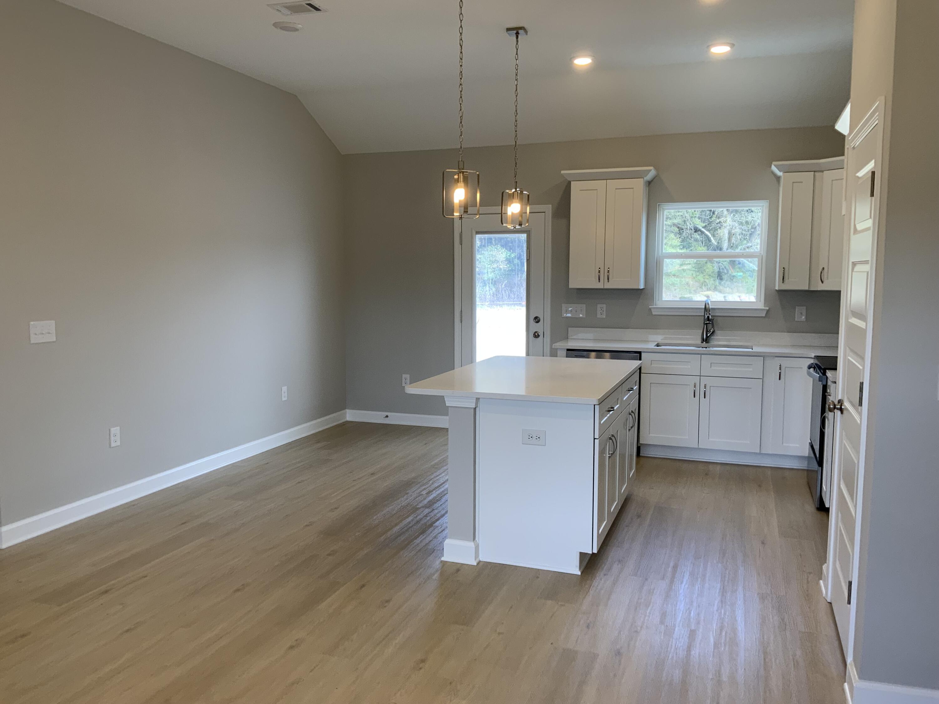 5239 Griffith Mill Road Baker, FL 32531 - Photo 4 of 9 a large kitchen with a lot of counter space and wooden floor
