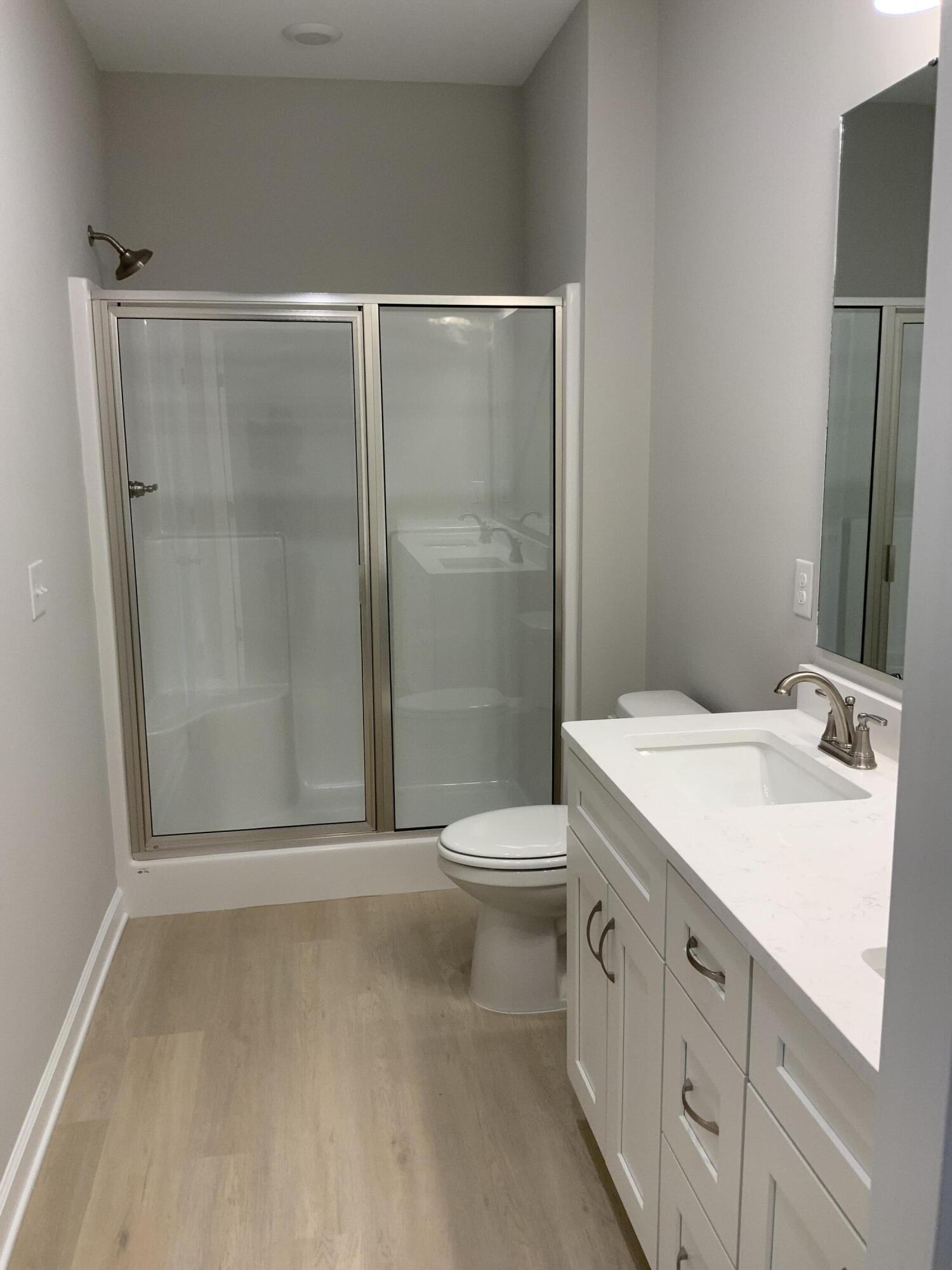 5239 Griffith Mill Road Baker, FL 32531 - Photo 6 of 9 a bathroom with a sink a toilet and shower