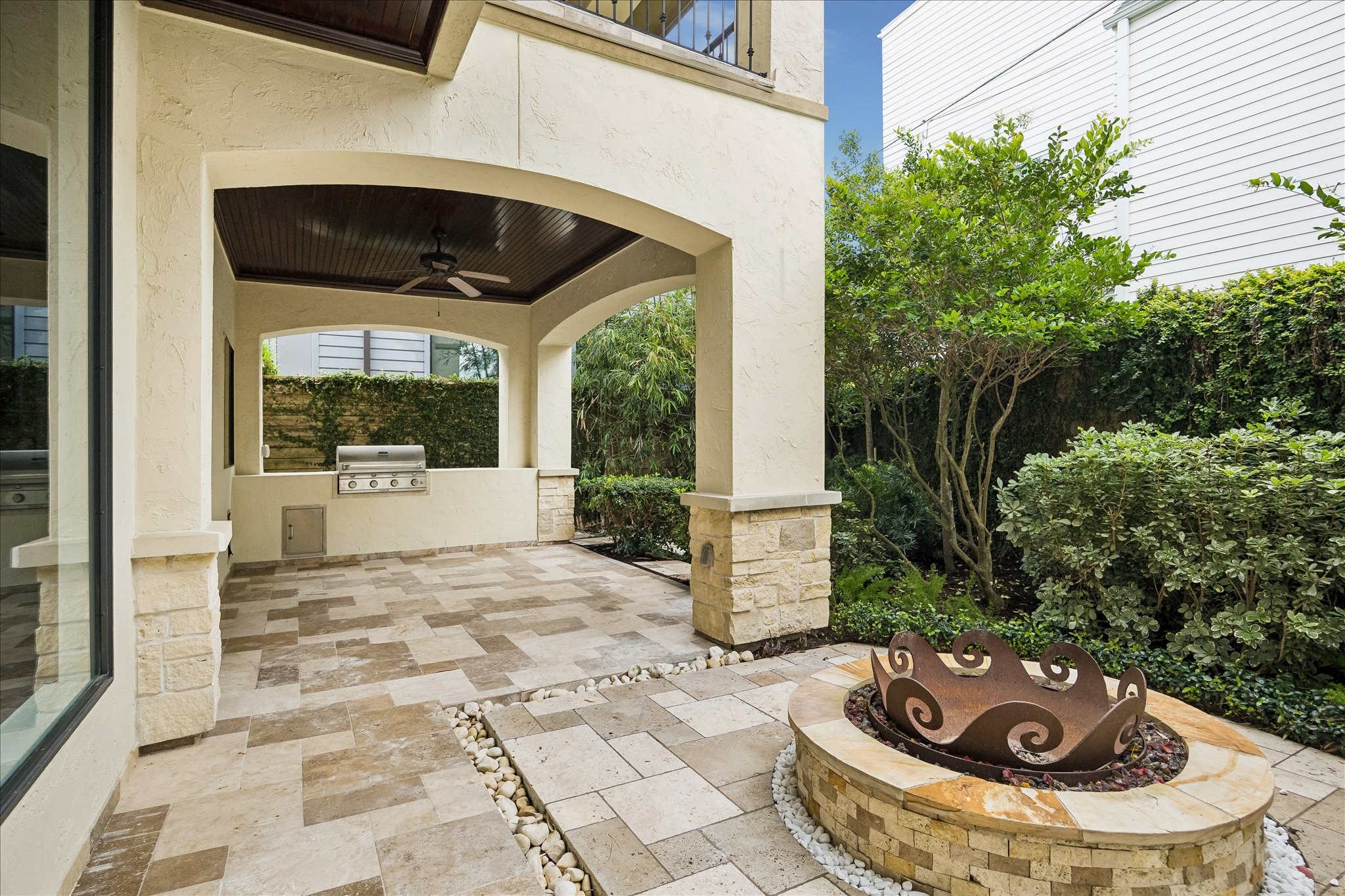 2246 Branard Street Houston, TX 77098 - Photo 37 of 40 A covered outdoor living area with travertine flooring, tongue-and-groove wood ceiling detail, and a built-in grill designed for effortless entertaining.