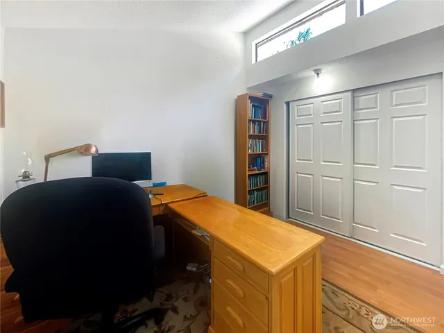 a blue bed sitting in a bedroom next to a cabinet