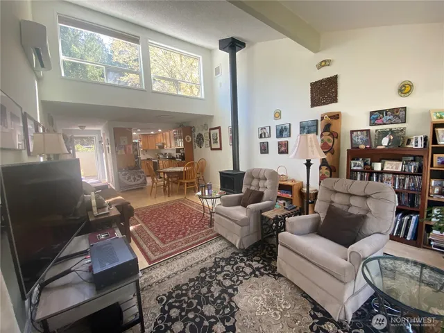 a living room with furniture fireplace and a large window