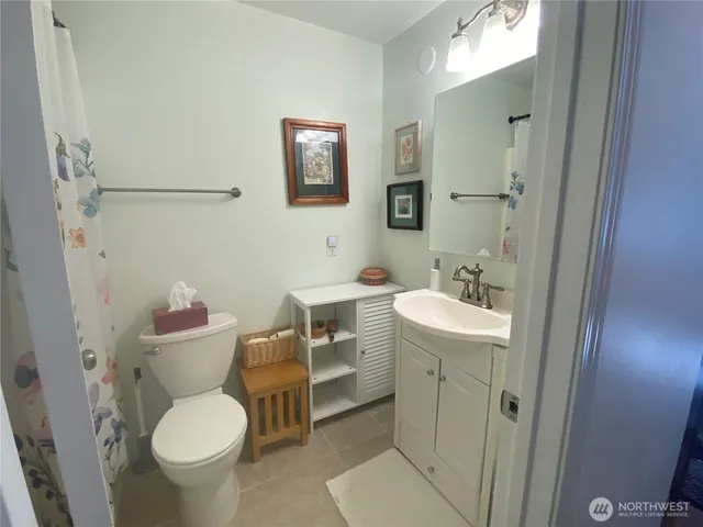 a bathroom with a sink toilet and a mirror