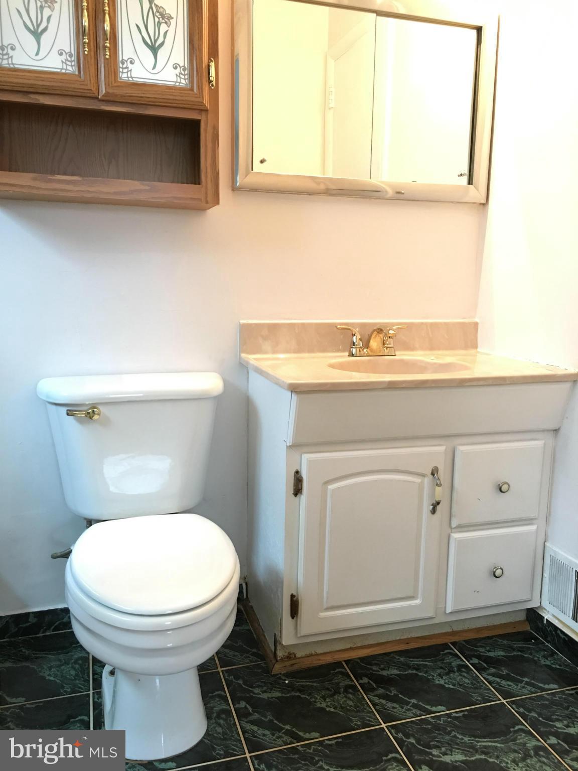 4307 Havard Street Silver Spring, MD 20906 - Photo 14 of 27 a bathroom with a toilet a sink and a window