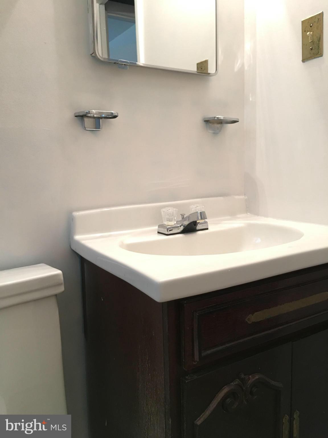 4307 Havard Street Silver Spring, MD 20906 - Photo 24 of 27 a bathroom with a sink a toilet and a mirror