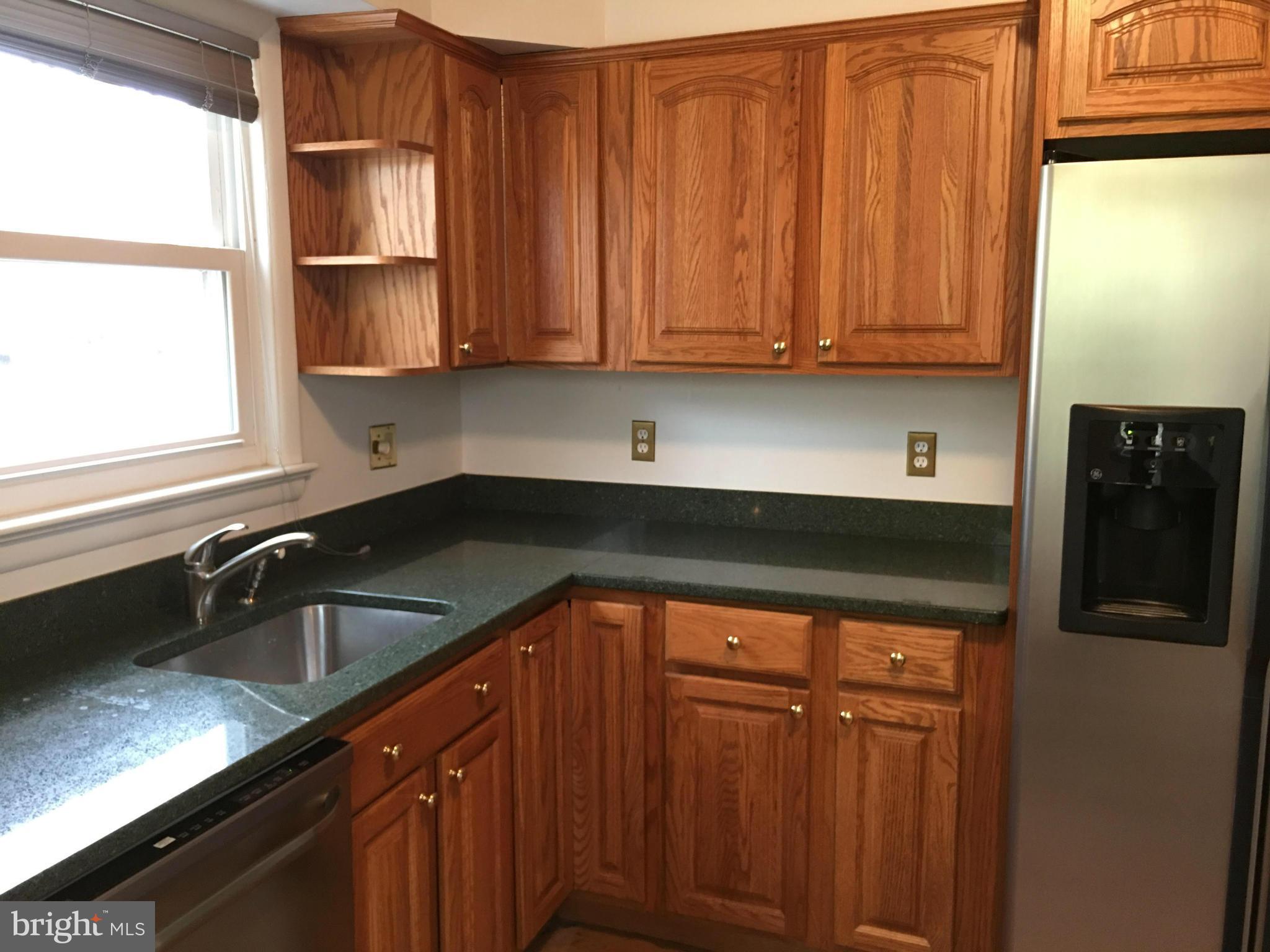 4307 Havard Street Silver Spring, MD 20906 - Photo 5 of 27 a kitchen with granite countertop stainless steel appliances a refrigerator and a sink