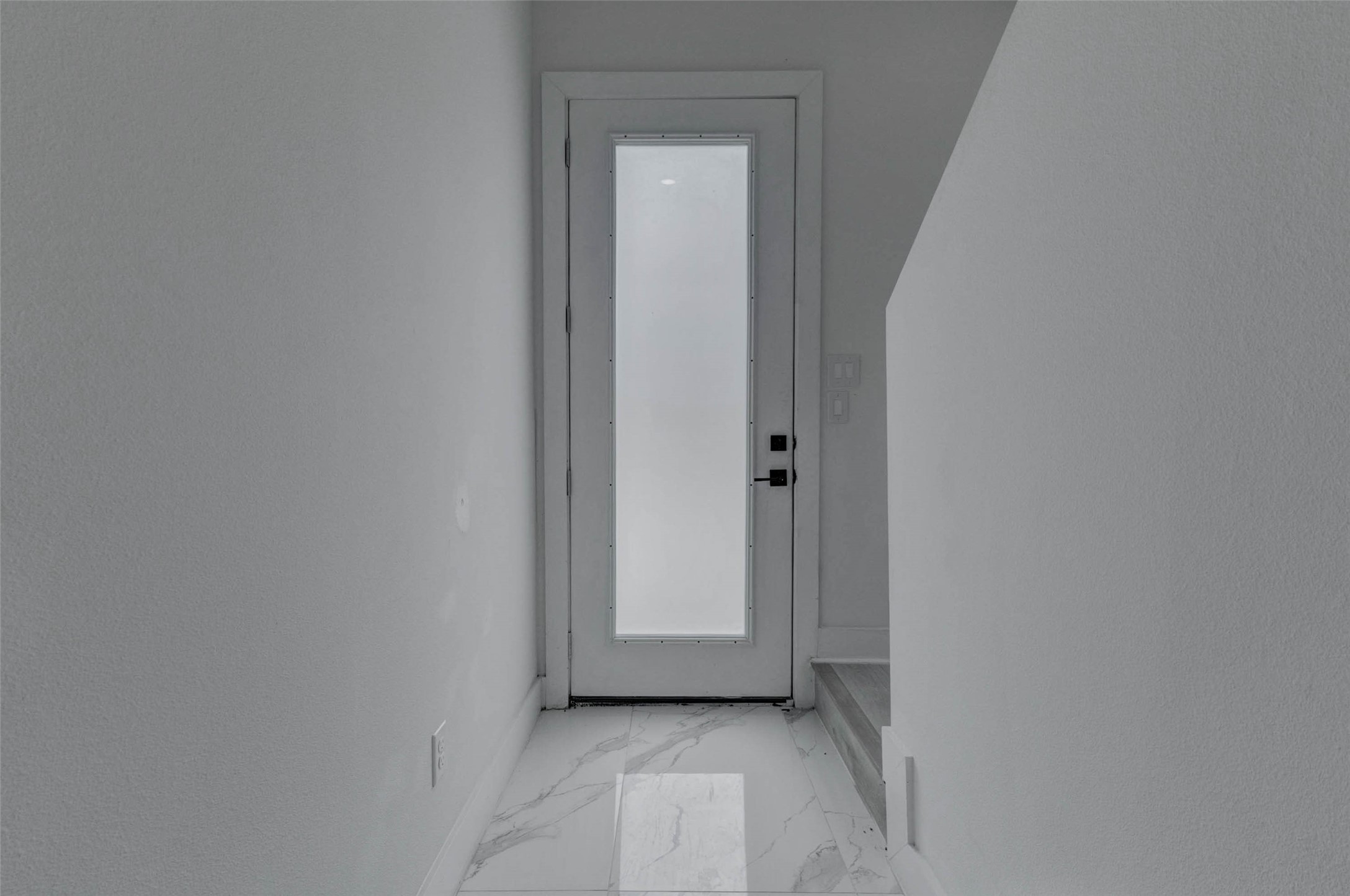 5705 Elysium Street Houston, TX 77091 - Photo 4 of 22 The interior hallway features a soft neutral color scheme, bright natural light, and a simple, modern layout that connects the home’s living areas with ease.