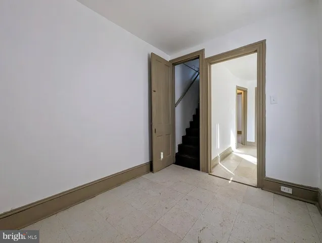 a view of a hallway with wooden walls and closet