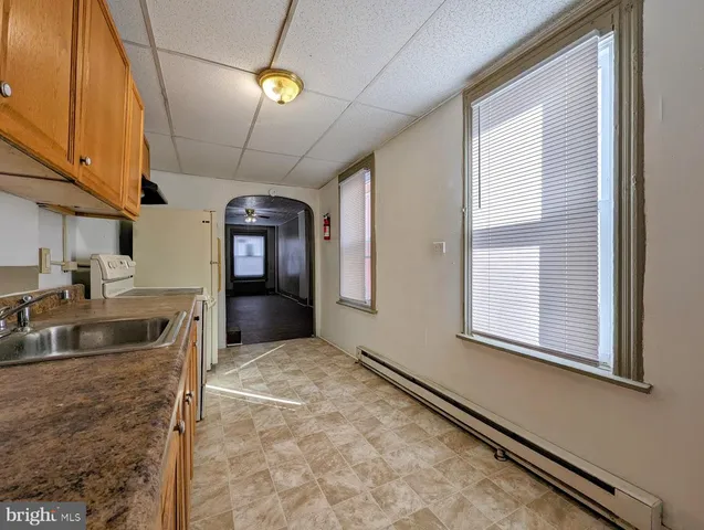 a view of a kitchen with a sink and cabinet area