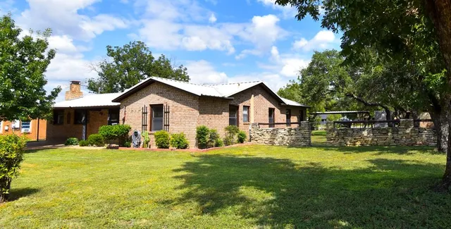 a front view of house with yard and green space