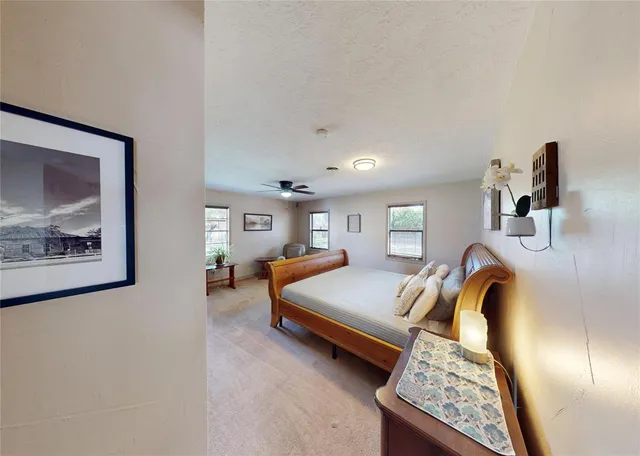 a bedroom with a bed and a painting on the wall