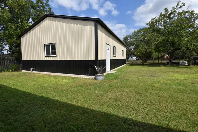 a front view of a house with a garden and yard