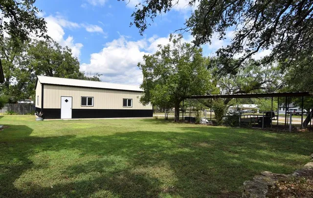 a front view of house with yard and trees
