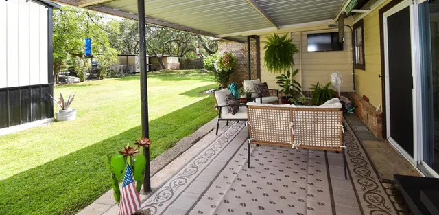 a view of a porch with chairs and backyard