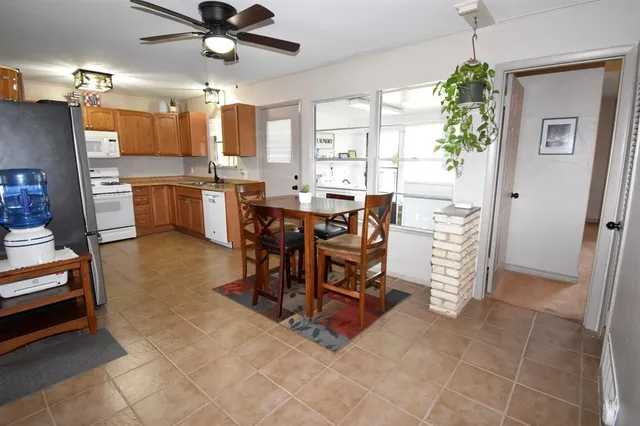 a view of a dining room with furniture and a chandelier