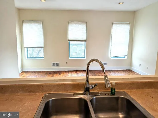 a view of a kitchen with a sink and cabinets