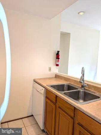 a utility room with sink and dryer