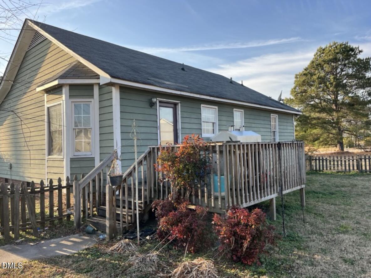 370 Sanders Road Benson, NC 27504 - Photo 13 of 13 a view of a house with a small yard and wooden fence