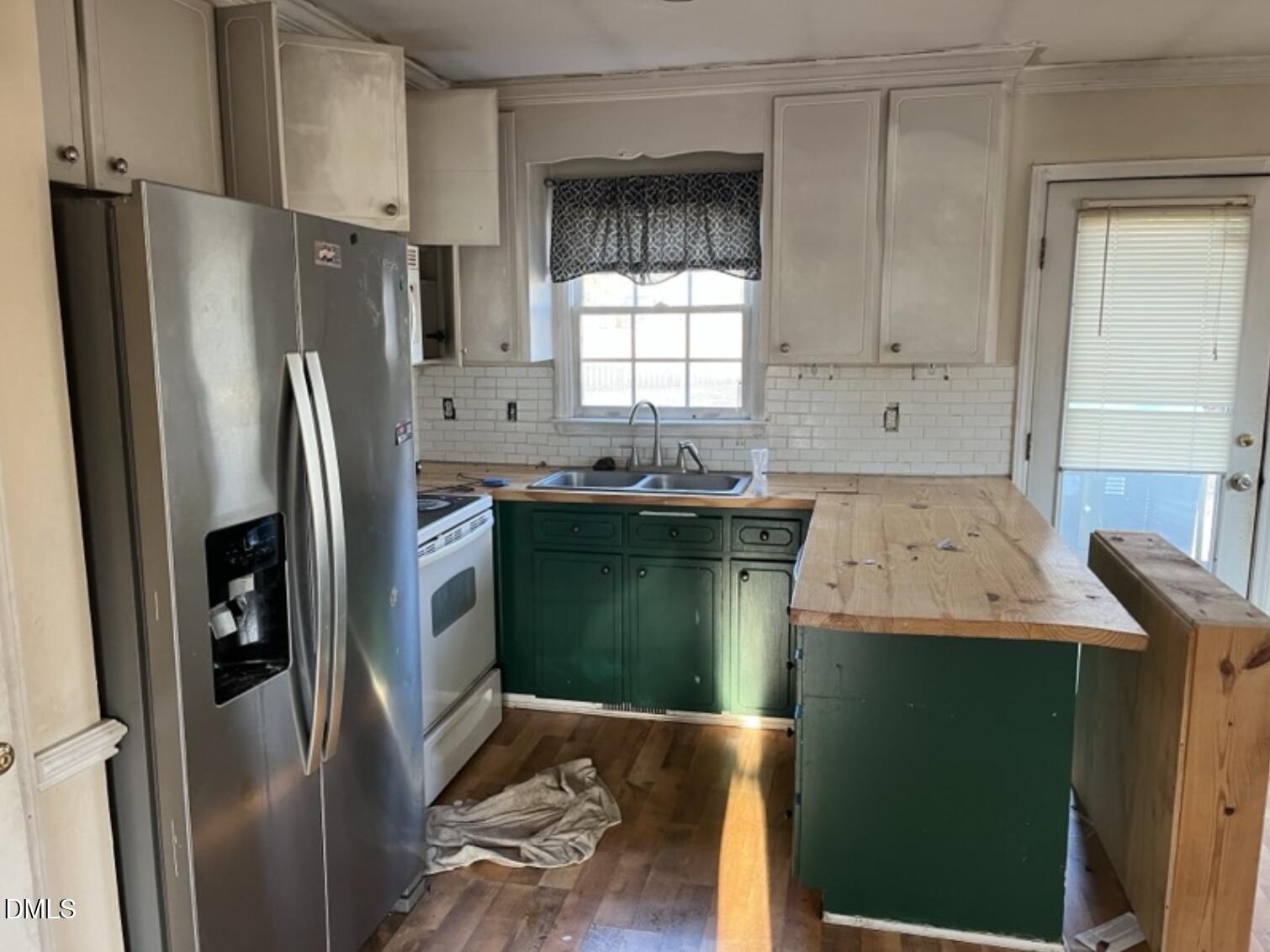 370 Sanders Road Benson, NC 27504 - Photo 7 of 13 a kitchen with a sink a refrigerator and window
