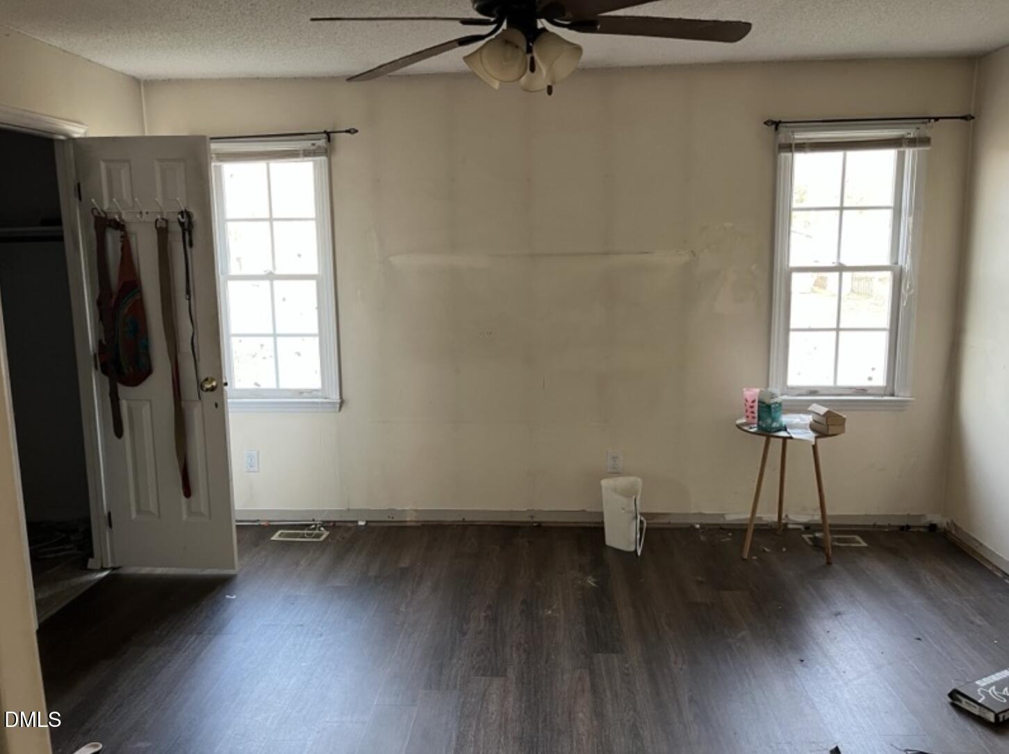 370 Sanders Road Benson, NC 27504 - Photo 10 of 13 an empty room with wooden floor and windows