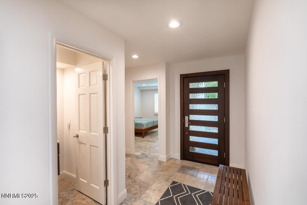 4811 Lakeridge Terrace West Reno, NV 89509 - Photo 5 of 43 a view of a hallway with wooden floor and windows