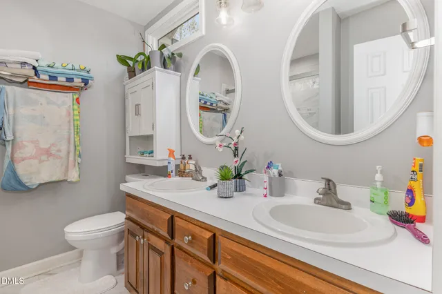 a bathroom with a sink mirror and toilet