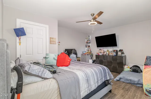 a bedroom with a bed and a flat screen tv