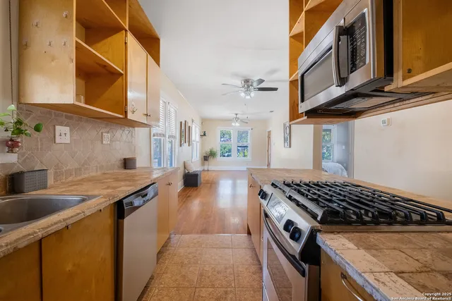 a kitchen with stainless steel appliances granite countertop a stove and a sink