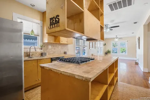 a kitchen that has a sink and a stove