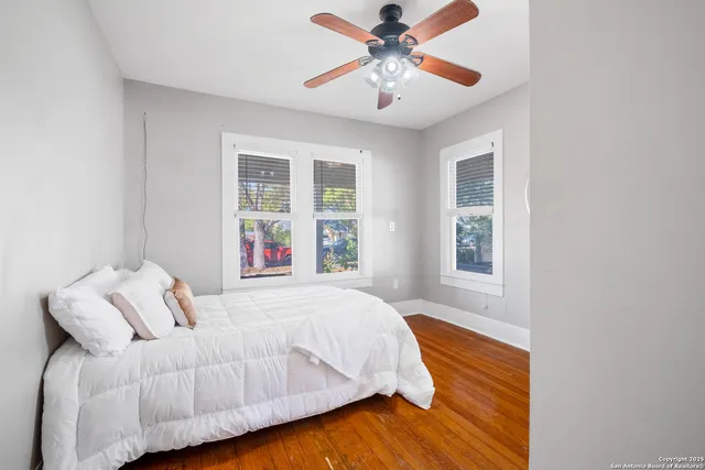 a bedroom with a bed and wooden floor