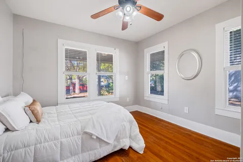a bedroom with a large bed and a window