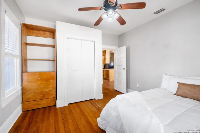 a bedroom with a bed and a window