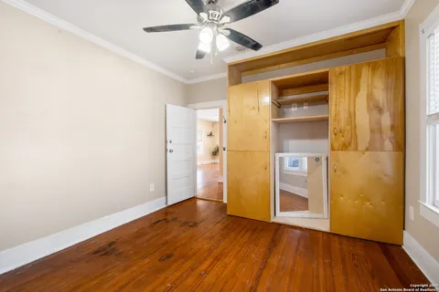 a view of empty room with wooden floor