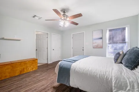 a bedroom with a bed and a ceiling fan