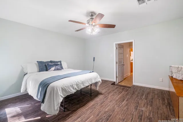 a bedroom with a bed and a ceiling fan